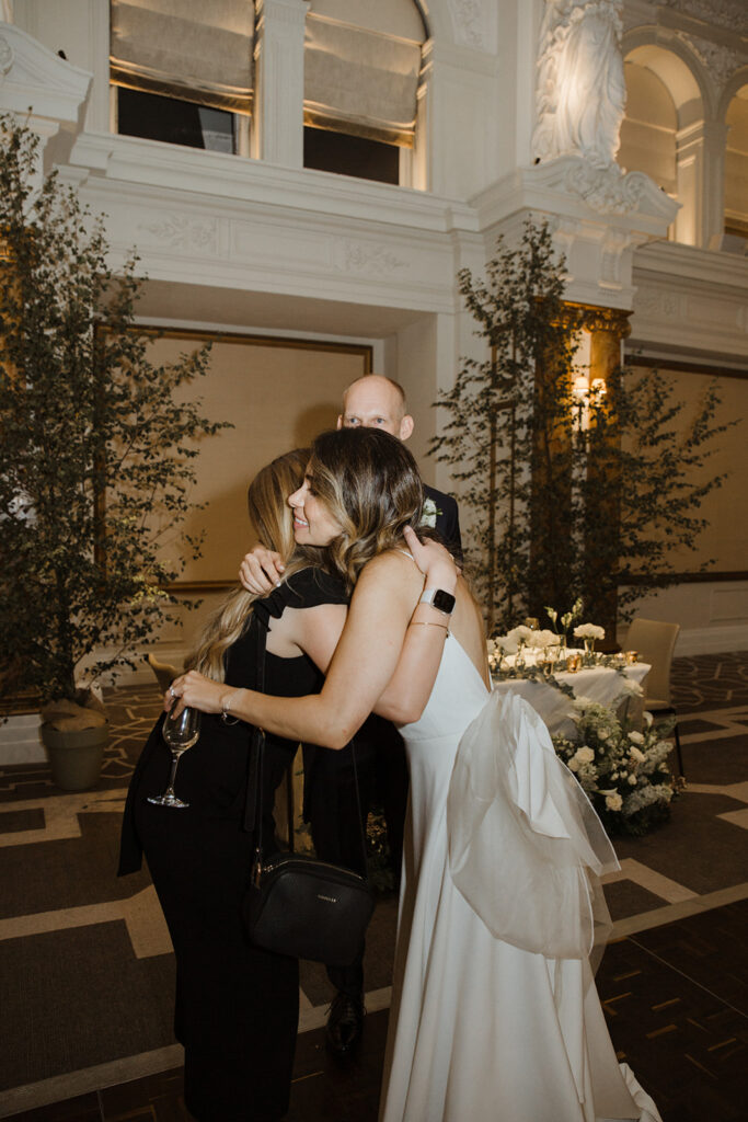 Bride and wedding planner hugging